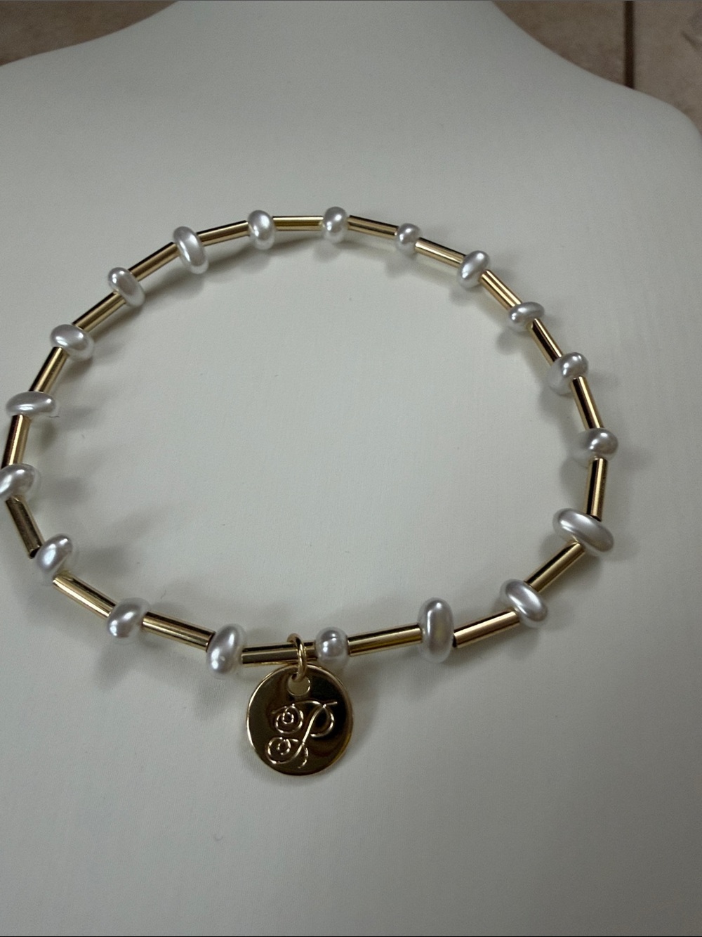 Plunder Gold Tone and White Pearl Stretch Bracelet with Logo Charm